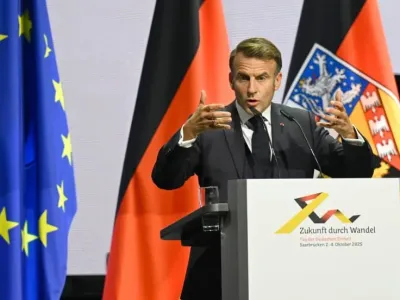 French President Emmanuel Macron speaks at the central celebrations for the Day of German Unity in the Congress Hall. On October 3, 2025, Germany celebrates the 35th anniversary of German reunification. Jean-Christophe Verhaegen/POOL AFP/dpa