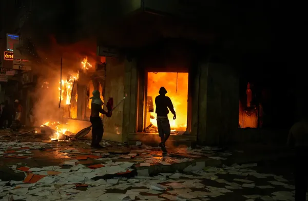 People torch and loot a bank as youth led protests calling for healthcare and education reforms turned violent, in Sale, Morocco, Wednesday, Oct. 1, 2025. (AP Photo/Mosa'ab Elshamy)(ASSOCIATED PRESS)