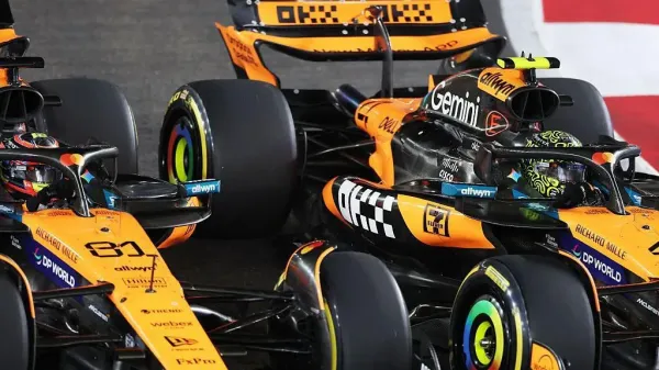 A close-up image of Lando Norris passing McLaren team-mate Oscar Piastri at the start of the Singapore Grand Prix