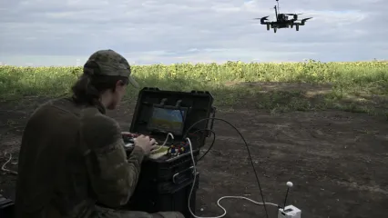 A drone pilot operates an FPV drone during a training flight in August 2025.