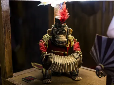 A monkey banging cymbals together.