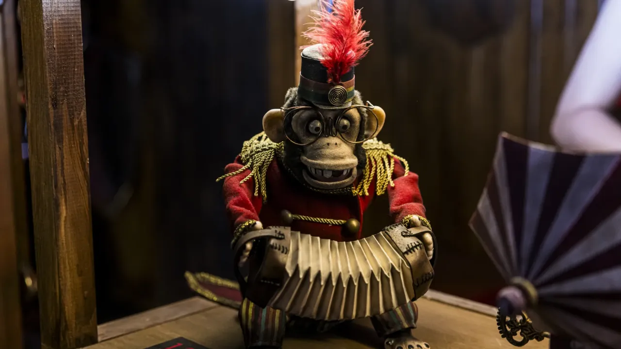 A monkey banging cymbals together.