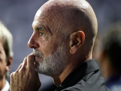 A pensive Stefano Pioli gazes into the distance.