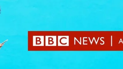 A woman looking at her mobile phone and the graphic BBC News Africa