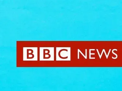 A woman looking at her mobile phone and the graphic BBC News Africa