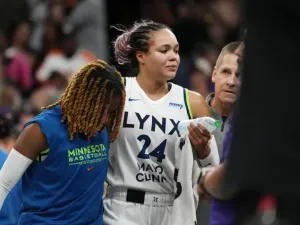 An injured Minnesota Lynx forward Napheesa Collier is helped off the court