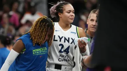 An injured Minnesota Lynx forward Napheesa Collier is helped off the court