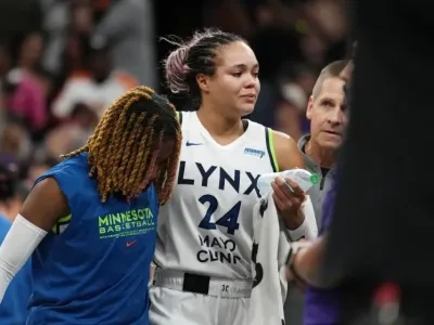 An injured Minnesota Lynx forward Napheesa Collier is helped off the court
