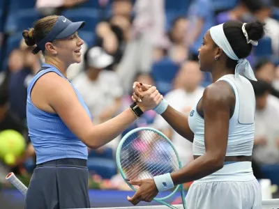Anisimova and Gauff shake hands after the 6-1 6-2 win  (AFP via Getty Images)