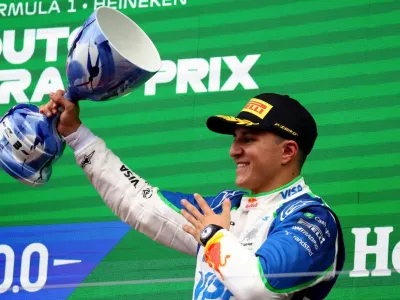 August 31, 2025 RB&#39;s Isack Hadjar celebrates on the podium with a trophy after finishing third place in the Dutch Grand Prix