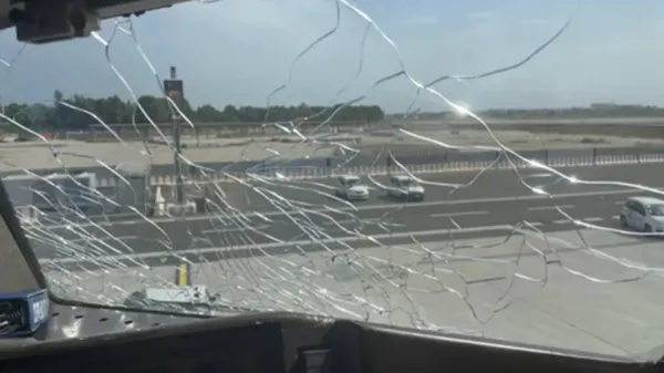 Broken Delta Air Lines cockpit window damaged by hail in 2023, according to Italian accident report. - ANSV