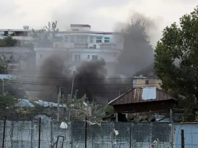 Dark smoke rises from a compound