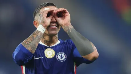 Enzo Fernandez cups hands around eyes celebrating win at end of match