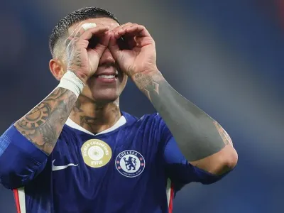 Enzo Fernandez cups hands around eyes celebrating win at end of match