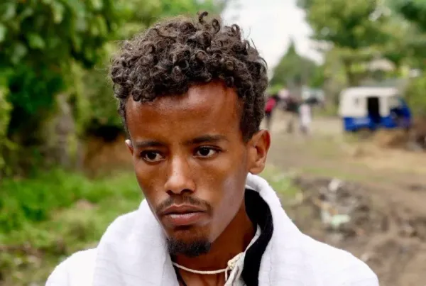  Fikre Tilahun, with a white top, stares
