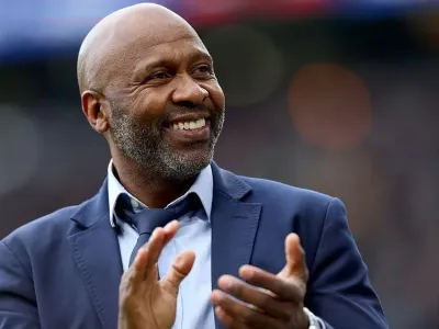 Former Leeds United player Lucas Radebe applauds the fans at half time