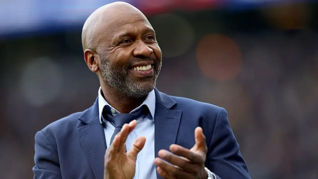 Former Leeds United player Lucas Radebe applauds the fans at half time