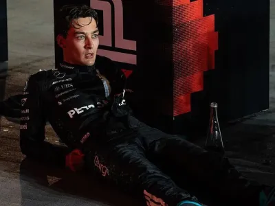 George Russell lying down and looking exhausted after the Singapore Grand Prix
