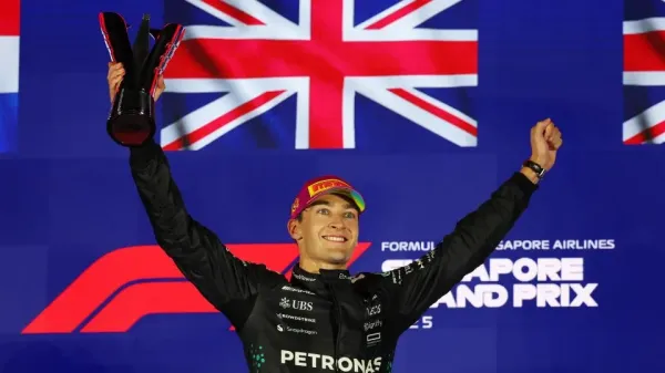 George Russell of Great Britain celebrate on the podium during the F1 Grand Prix of Singapore at Marina Bay Street Circuit. - Clive Rose/Getty Images
