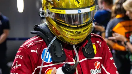 Lewis Hamilton of Great Britain and Ferrari walks in the paddock