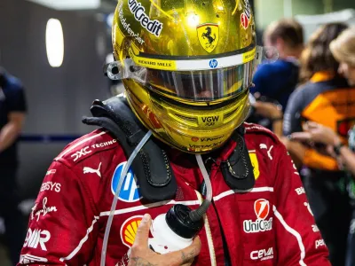 Lewis Hamilton of Great Britain and Ferrari walks in the paddock