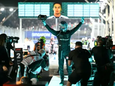 Mercedes driver George Russell celebrates his victory in the Singapore Grand Prix (MOHD RASFAN)