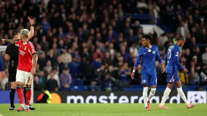 Referee Daniel Siebert shows a red card to Joao Pedro