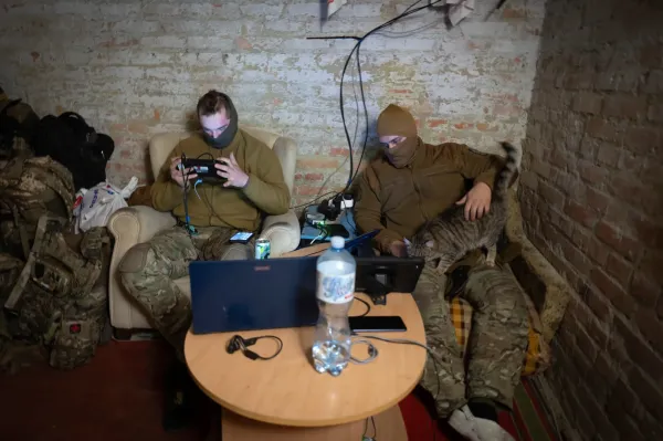 Servicemen of Ukraine's Khartia brigade pilot drones in a shelter on the frontline near Kharkiv, Ukraine, Thursday, Nov. 7, 2024. (